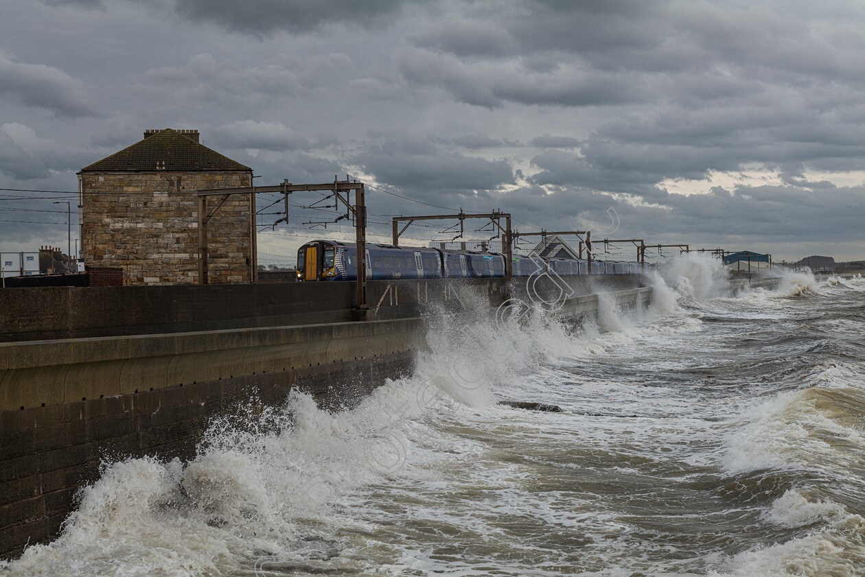 Saltcoats 
 Pretwick to Glasgow Scotrail train passes through Saltcoats on the West of Scotland, just as the tide and wind give every carriage a quick wash. 
 Keywords: Saltcoats Train, West Coast, Scotrail, Coastal Route